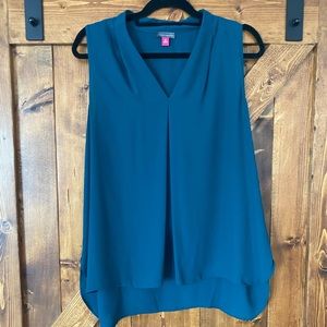 Peacock green sleeveless blouse.